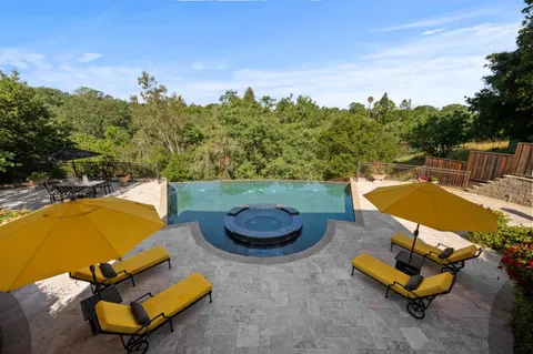 a view of a swimming pool with a chairs