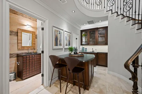 a view of a patio with table and chairs under an umbrella