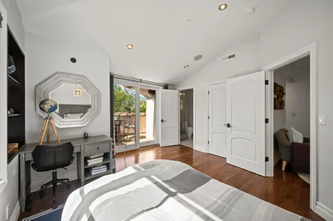 an aerial view of residential houses with outdoor space and trees