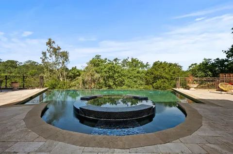 a living room with furniture large window and a table