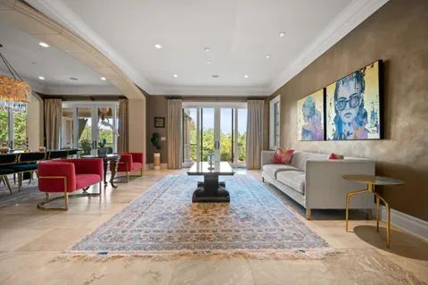 a living room with dining table and a table