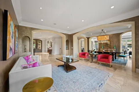 a living room with fireplace furniture and a large window