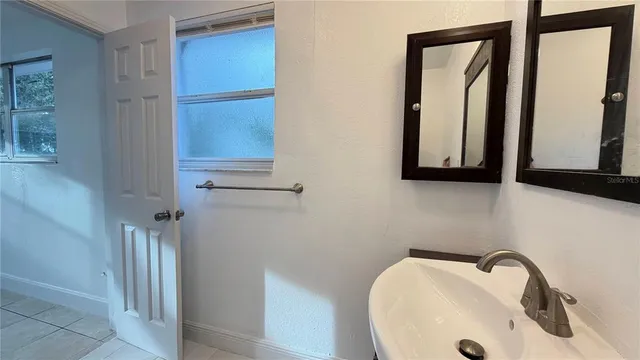 a bathroom with a sink and mirror