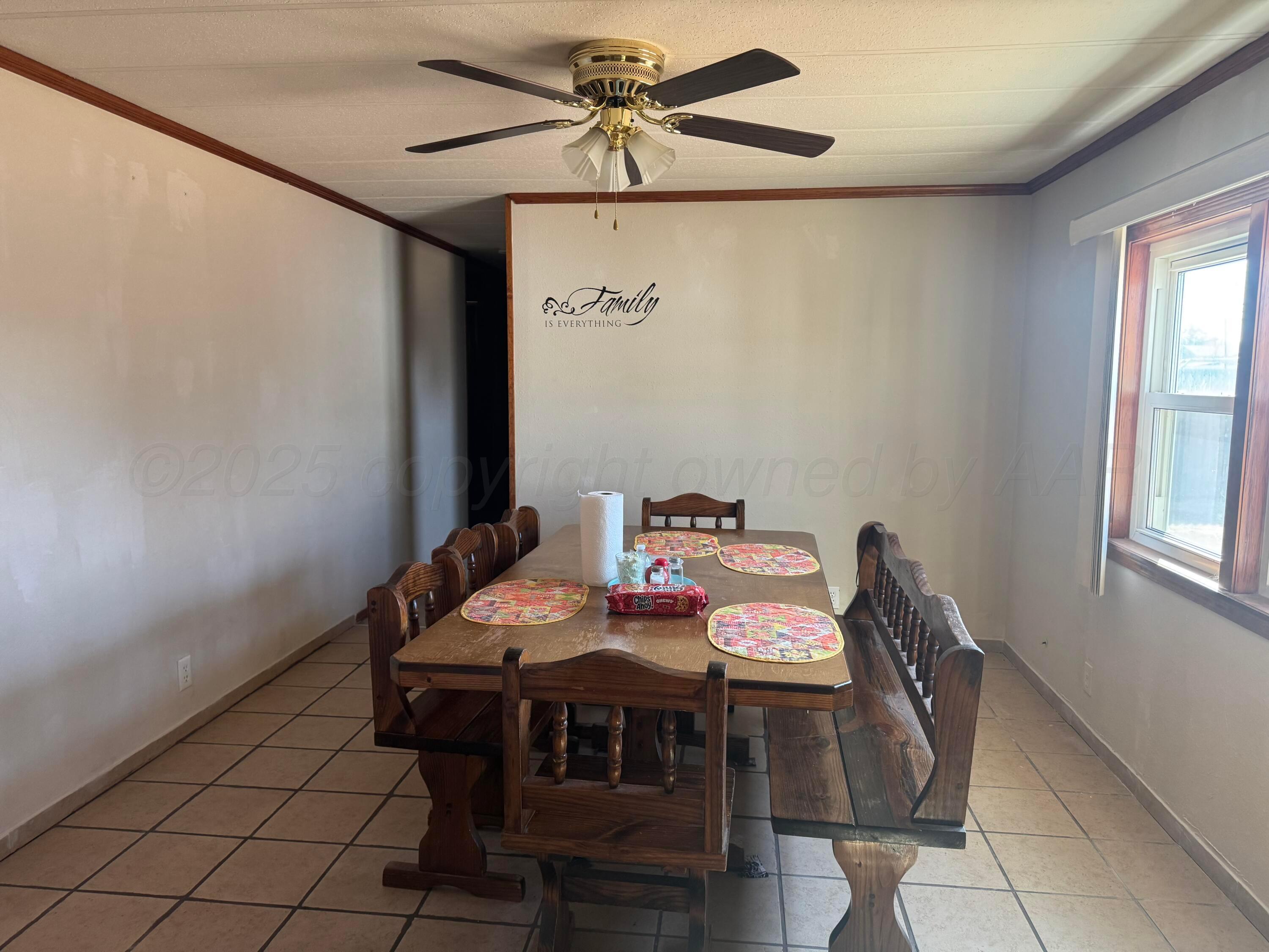 1702 South Baylor Street Perryton, TX 79070 - Photo 19 of 29 a view of a dining room with furniture and window