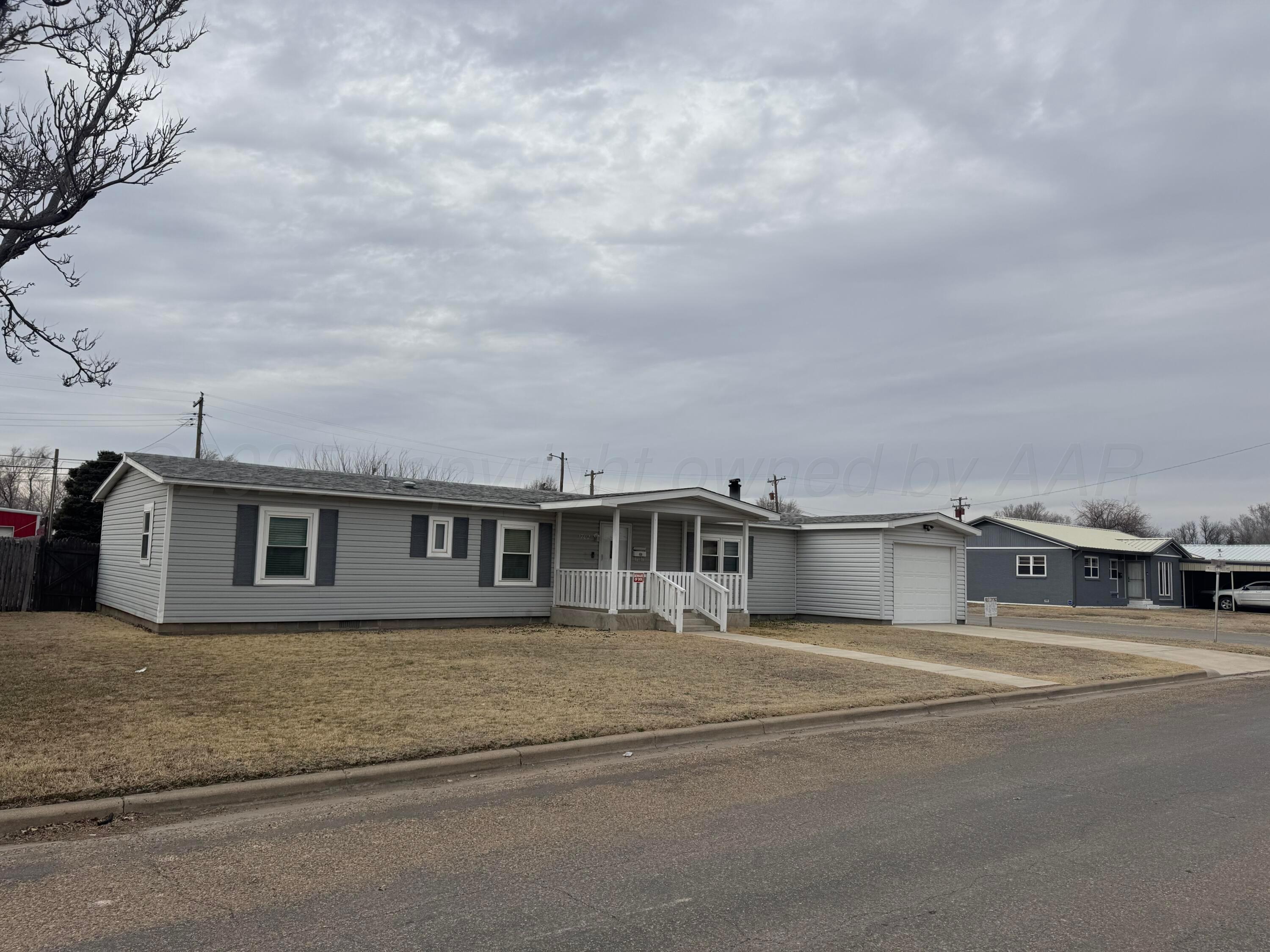 1702 South Baylor Street Perryton, TX 79070 - Photo 2 of 29 a view of a house with a street