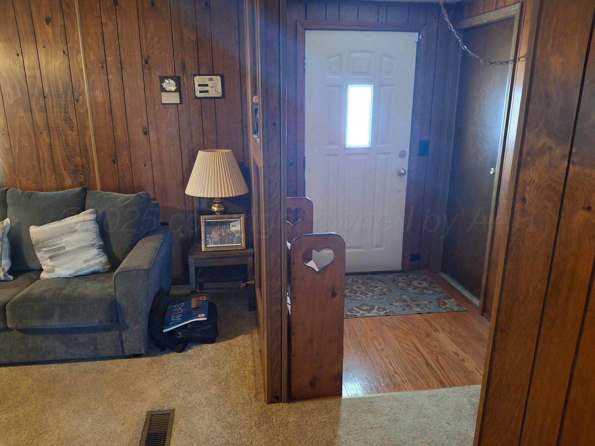 1702 South Baylor Street Perryton, TX 79070 - Photo 29 of 29 a living room with furniture and a wooden floor
