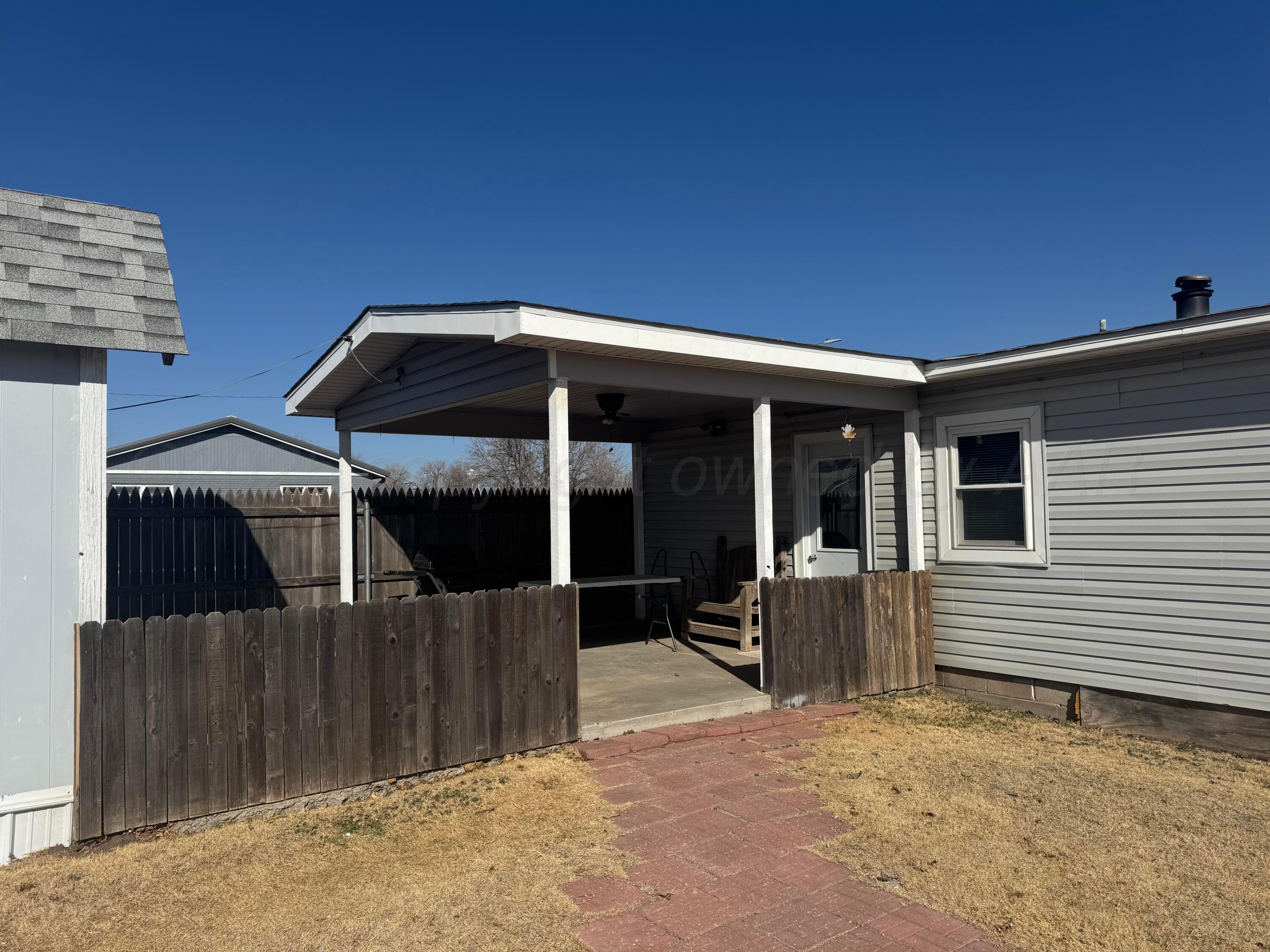 1702 South Baylor Street Perryton, TX 79070 - Photo 5 of 29 a front view of a house with a porch