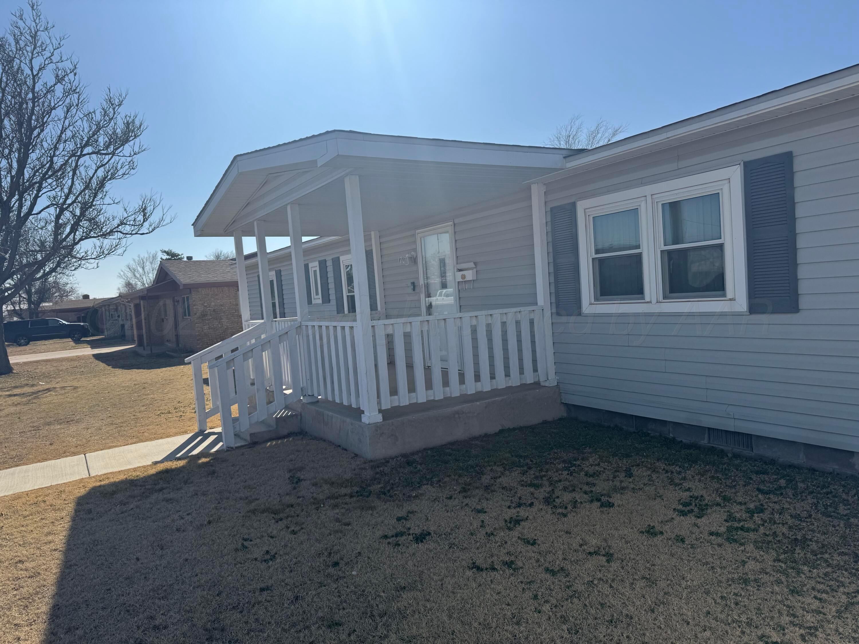 1702 South Baylor Street Perryton, TX 79070 - Photo 7 of 29 a view of a house with a yard