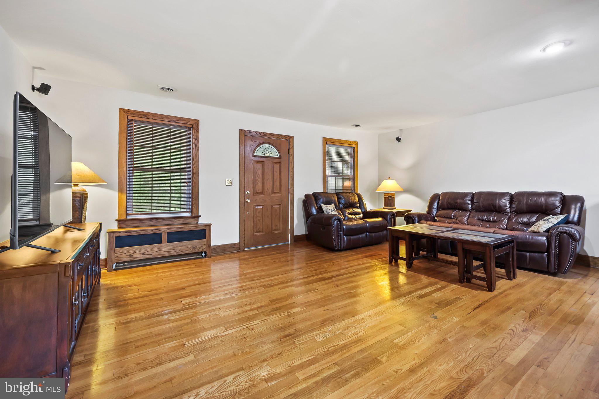 1218 Lower Ferry Road Ewing, NJ 08618 - Photo 11 of 39 a living room with furniture and a wooden floor
