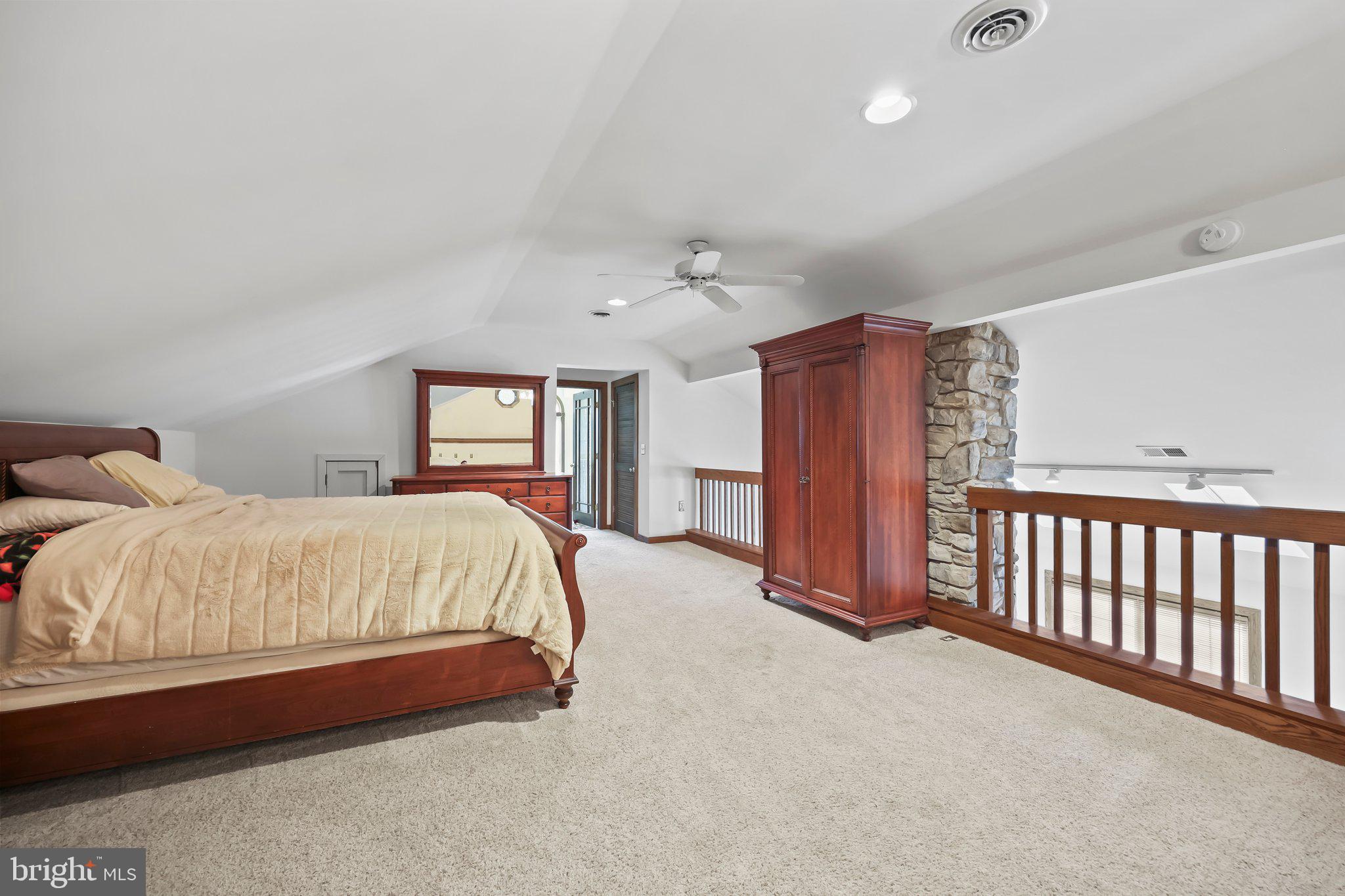 1218 Lower Ferry Road Ewing, NJ 08618 - Photo 18 of 39 a spacious bedroom with a bed and a chandelier