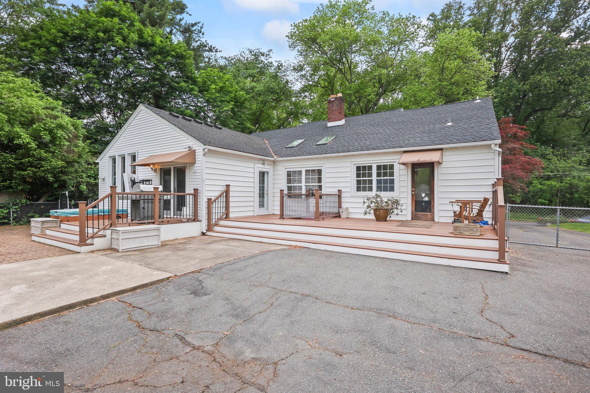 1218 Lower Ferry Road Ewing, NJ 08618 - Photo 33 of 39 a view of a house with a swimming pool and a large tree