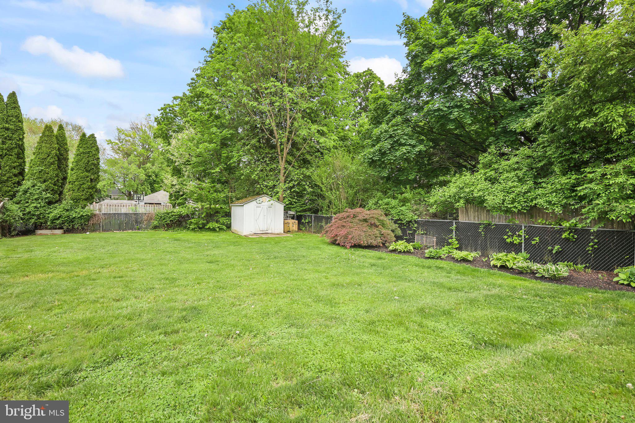 1218 Lower Ferry Road Ewing, NJ 08618 - Photo 34 of 39 a backyard of a house with a garden and plants
