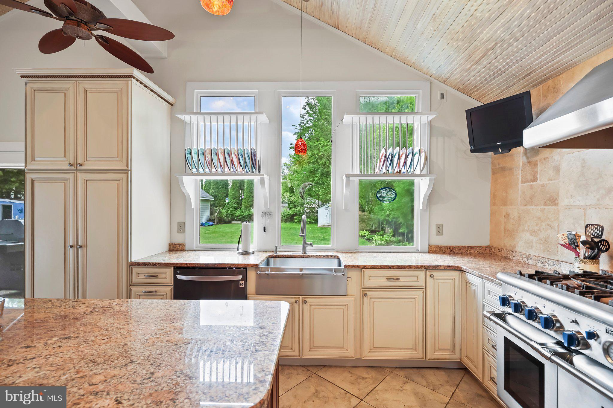 1218 Lower Ferry Road Ewing, NJ 08618 - Photo 7 of 39 a kitchen with a stove a sink and a refrigerator