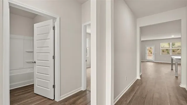 a view of a hallway with wooden floor and closet