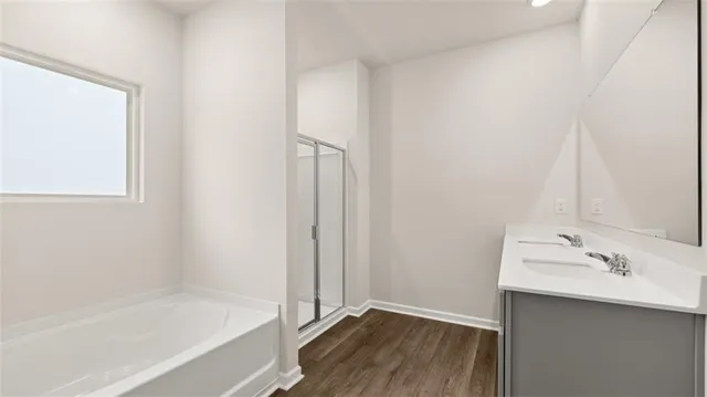 a bathroom with a bathtub sink and mirror