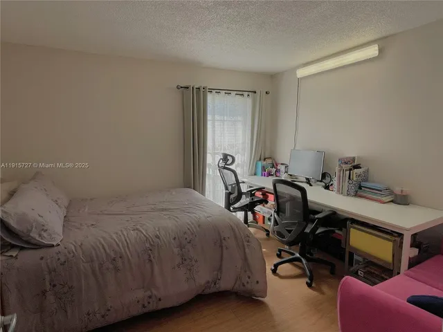 a bed room with a bed and a chair