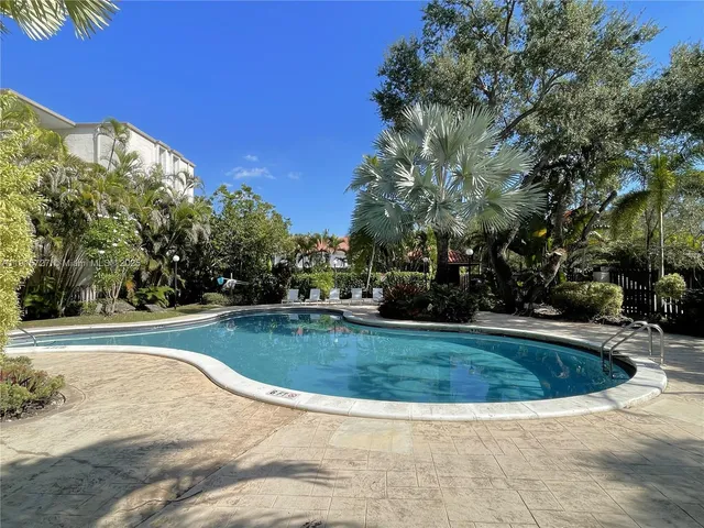 a view of a swimming pool with a yard