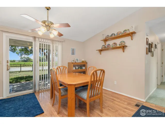a view of a dining room with furniture wooden floor and chandelier