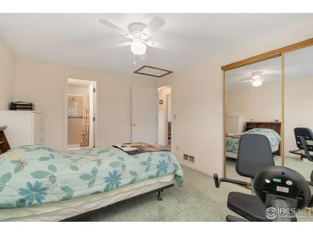 a bedroom with a bed and chandelier