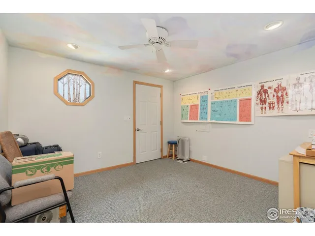 a view of an empty room with a ceiling fan