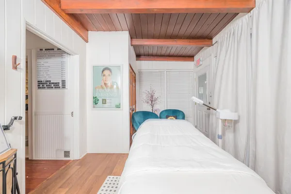 a picture of a bedroom that has a bed and a window