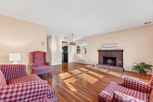 a bedroom with furniture and a wooden floor