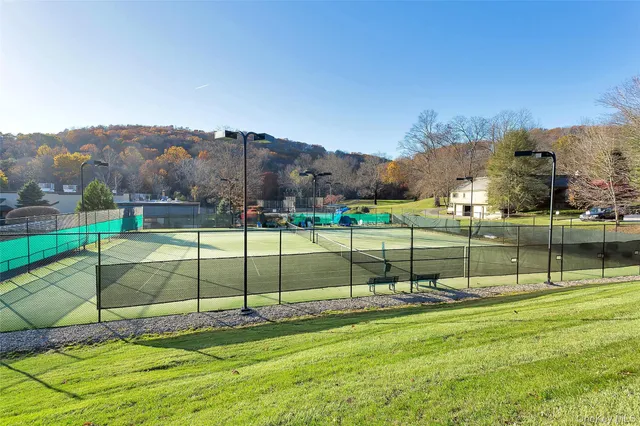swimming pool view with a seating space and garden view