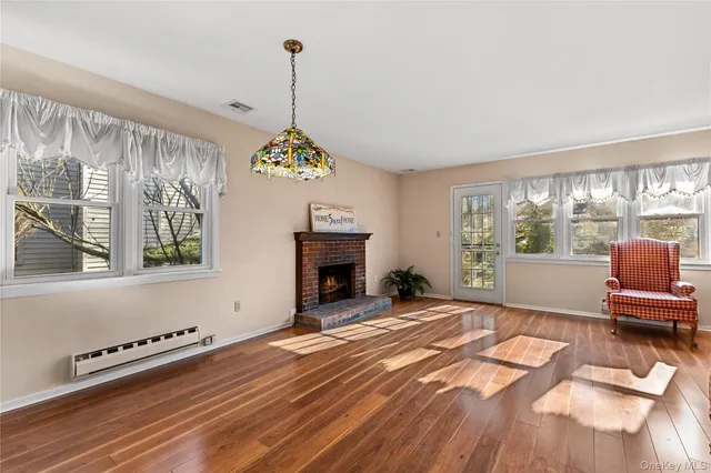 a view of a house with pool and trees in the background