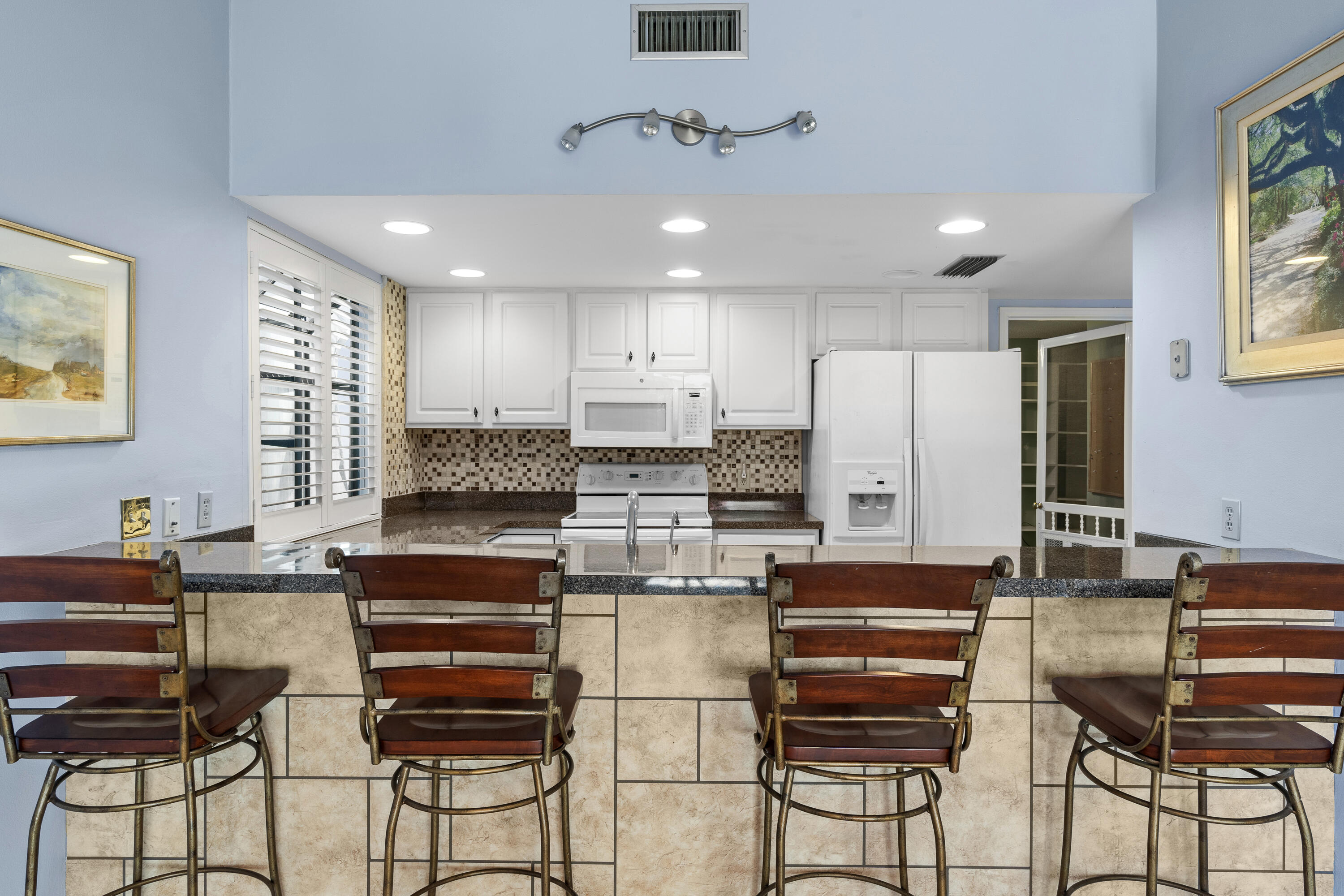 351 L'Atrium Drive Miramar Beach, FL 32550 - Photo 12 of 48 a kitchen with stainless steel appliances granite countertop a stove and cabinets