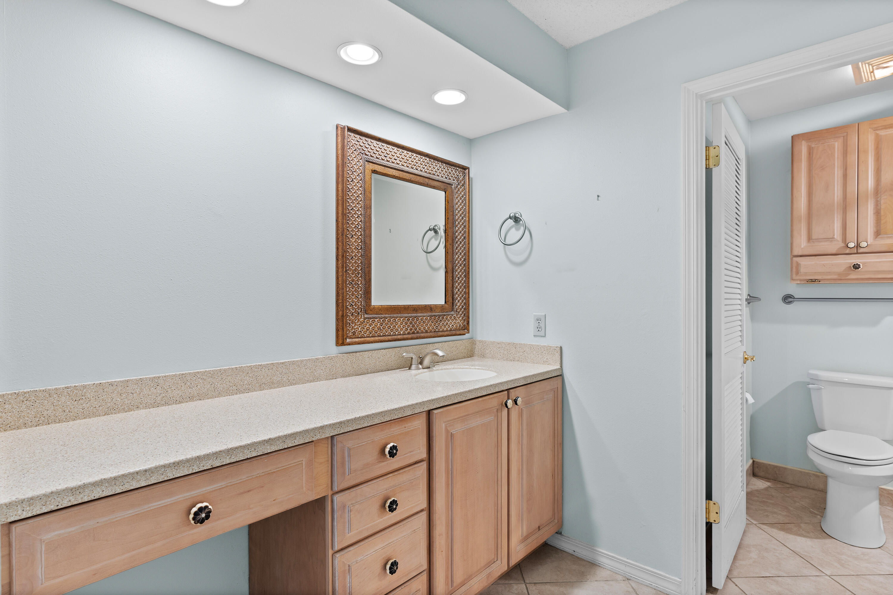 351 L'Atrium Drive Miramar Beach, FL 32550 - Photo 21 of 48 a bathroom with a sink a toilet and mirror