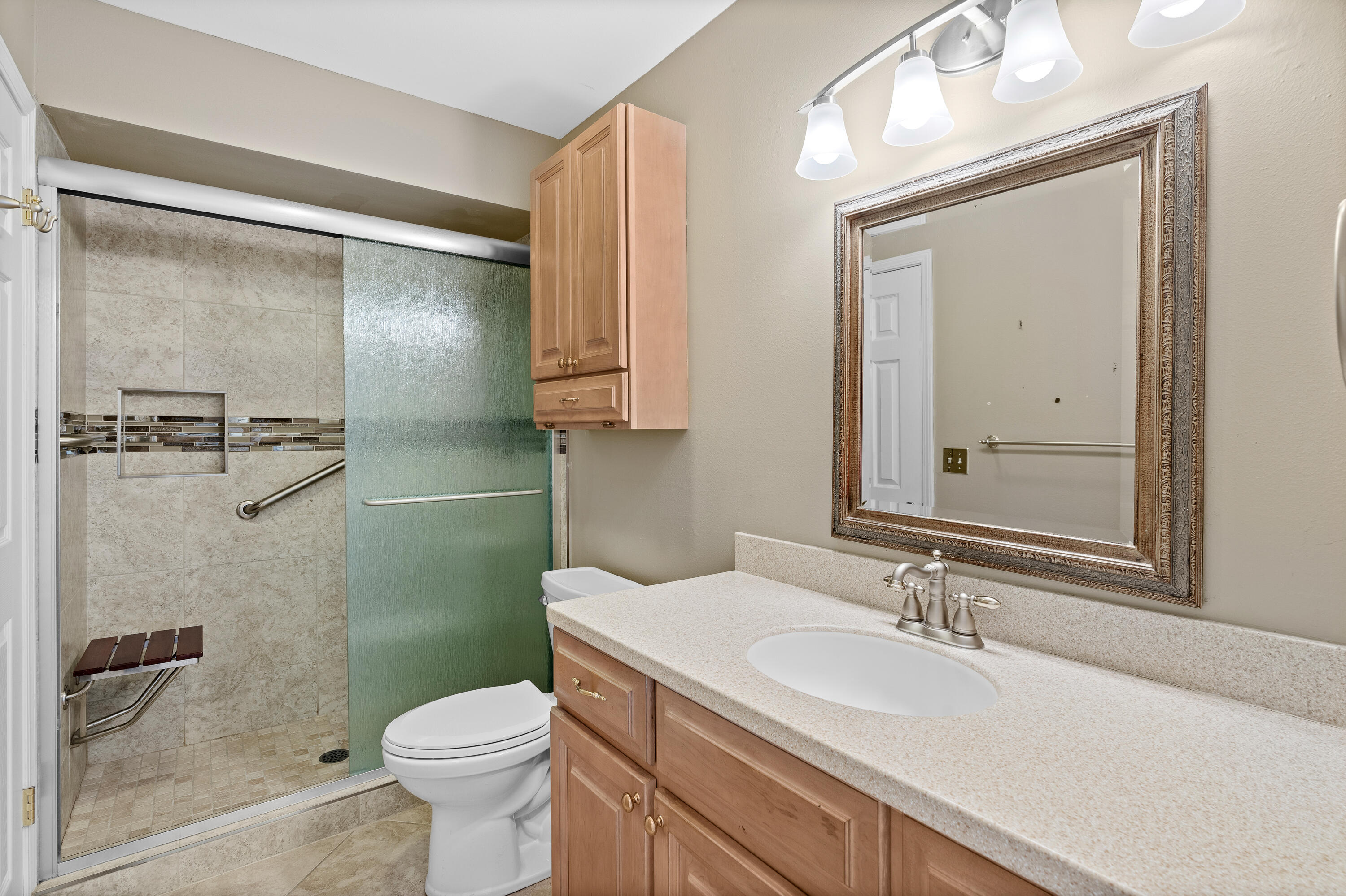 351 L'Atrium Drive Miramar Beach, FL 32550 - Photo 25 of 48 a bathroom with a granite countertop sink toilet and shower