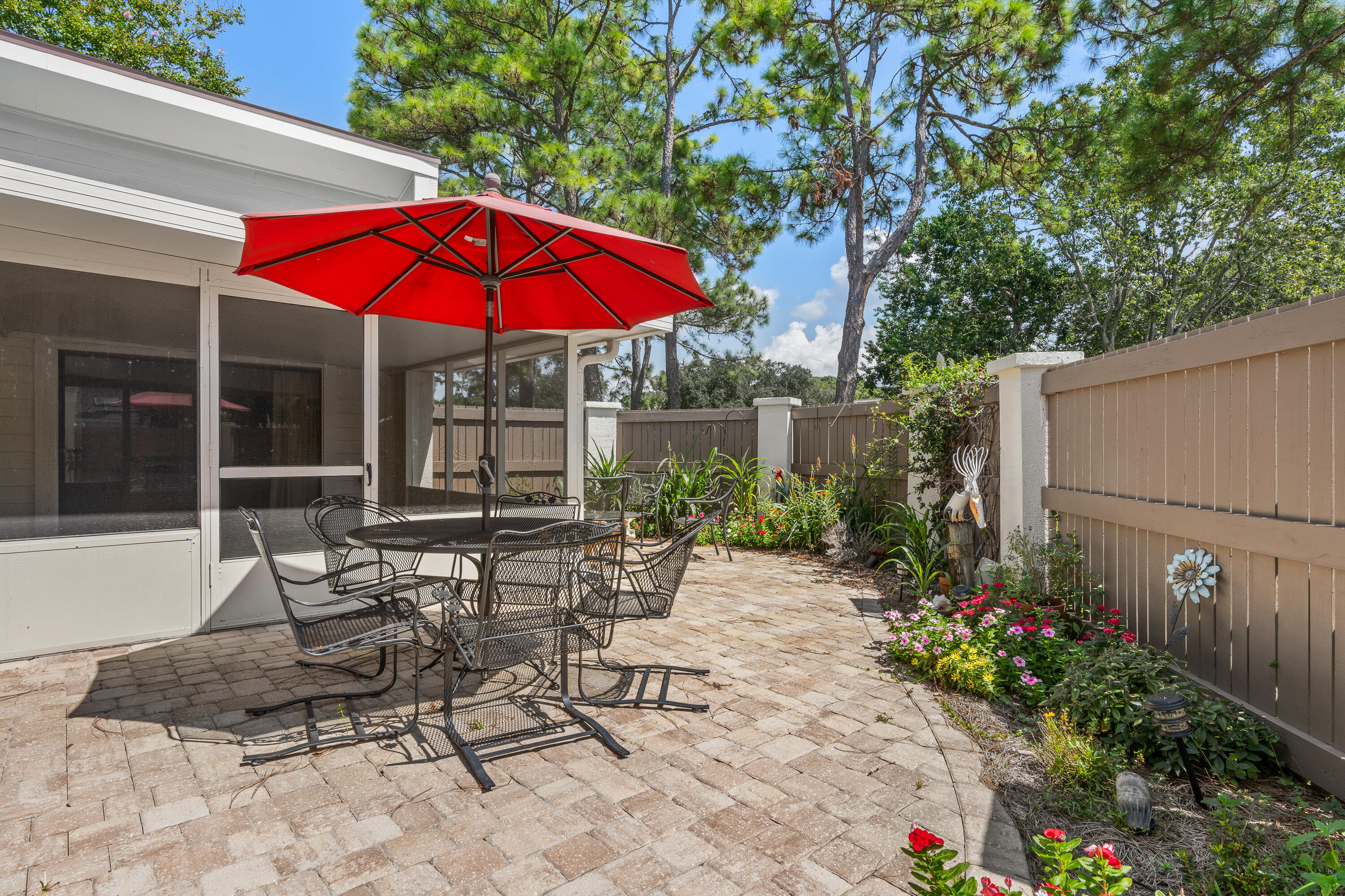 351 L'Atrium Drive Miramar Beach, FL 32550 - Photo 29 of 48 a patio with a table and chairs under an umbrella