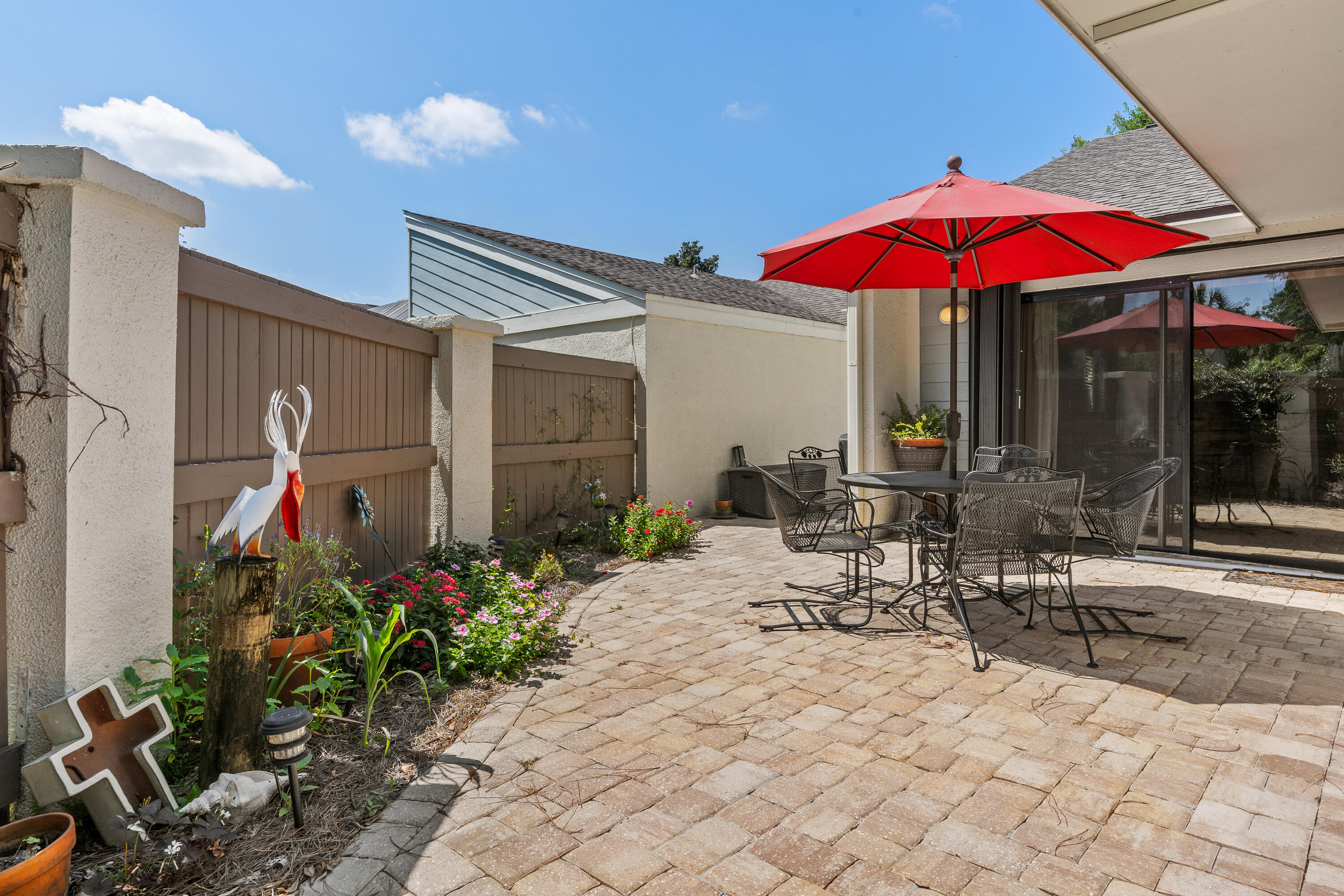 351 L'Atrium Drive Miramar Beach, FL 32550 - Photo 30 of 48 a view of the patio with chairs and tables under an umbrella