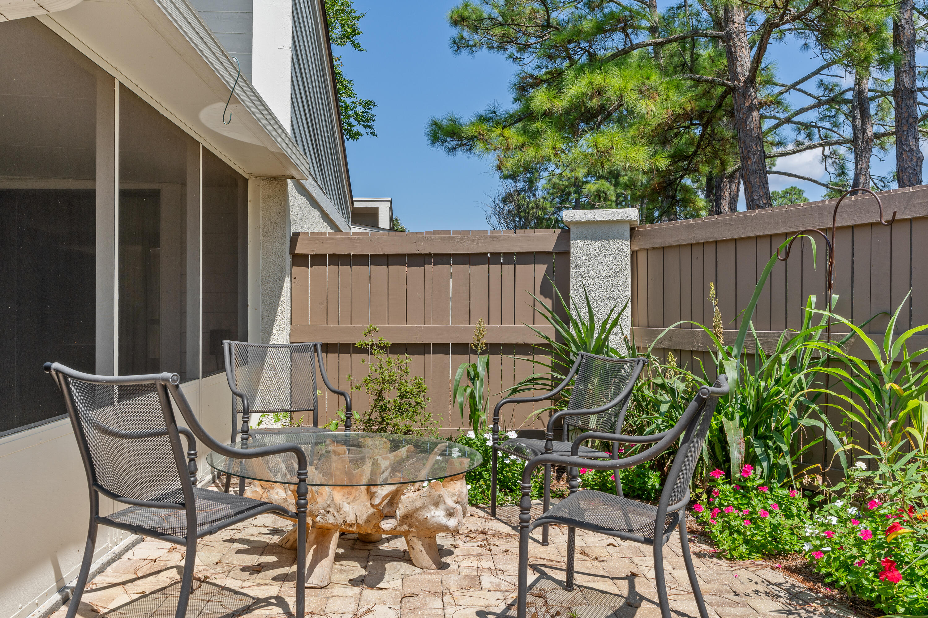 351 L'Atrium Drive Miramar Beach, FL 32550 - Photo 31 of 48 a view of outdoor seating area with green plants and wooden fence