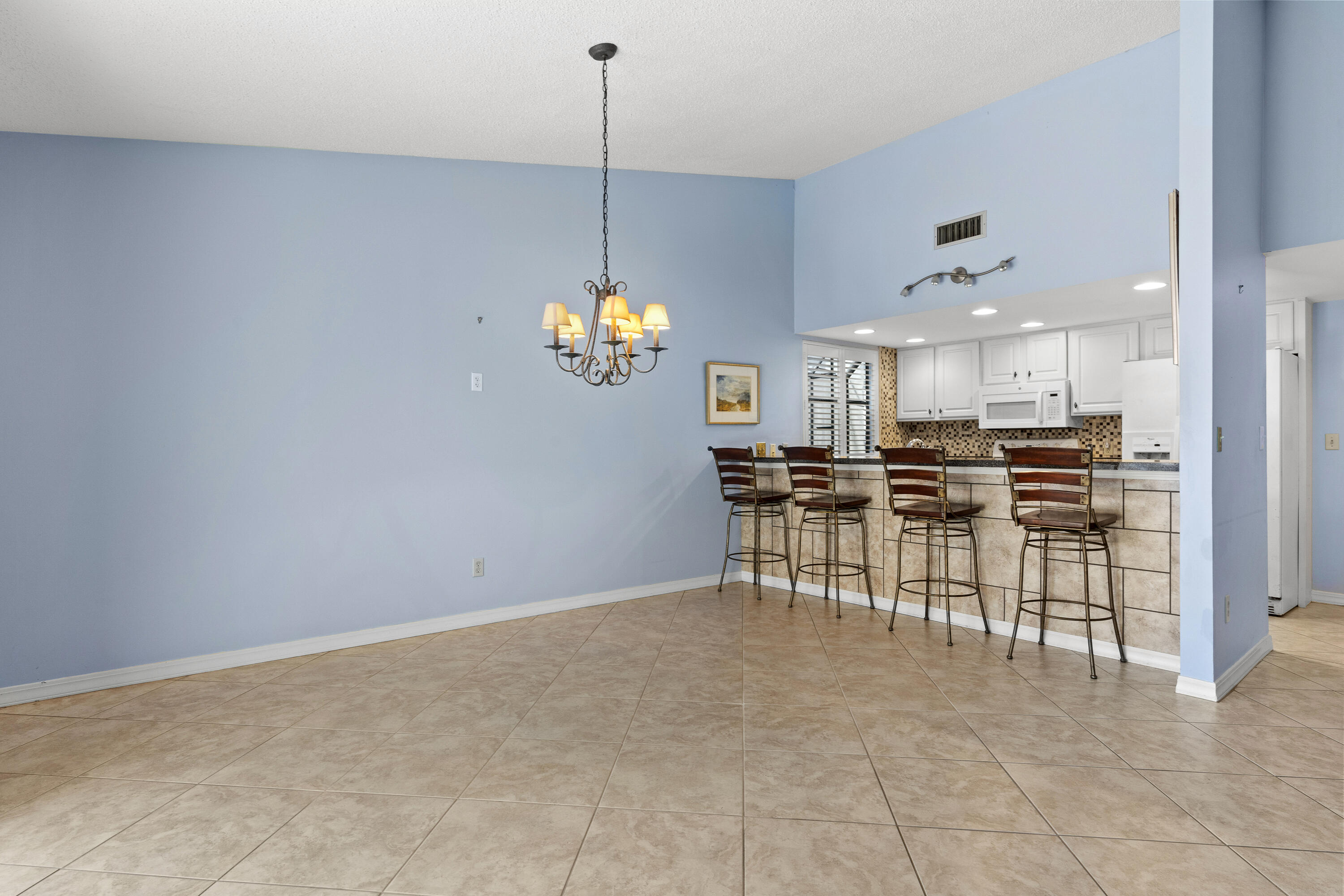 351 L'Atrium Drive Miramar Beach, FL 32550 - Photo 10 of 48 a view of a dining room and kitchen with furniture and chandelier