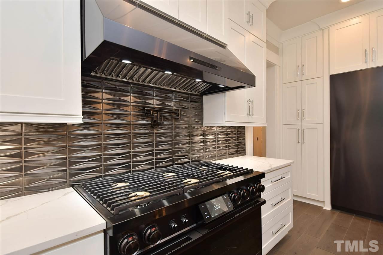 1417 Sky Vista Way Raleigh, NC 27613 - Photo 12 of 26 a stove top oven sitting inside of a kitchen
