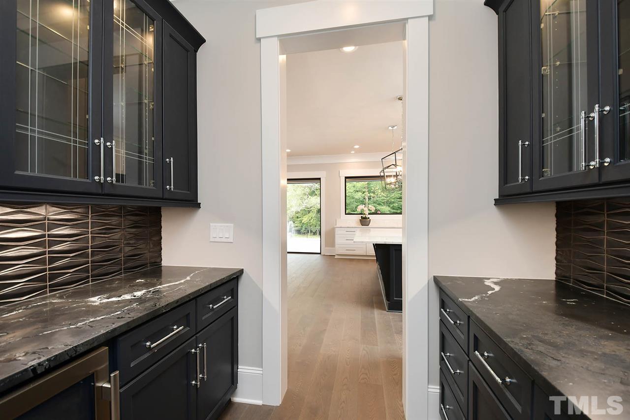 1417 Sky Vista Way Raleigh, NC 27613 - Photo 14 of 26 a kitchen with granite countertop a stove a sink and a microwave