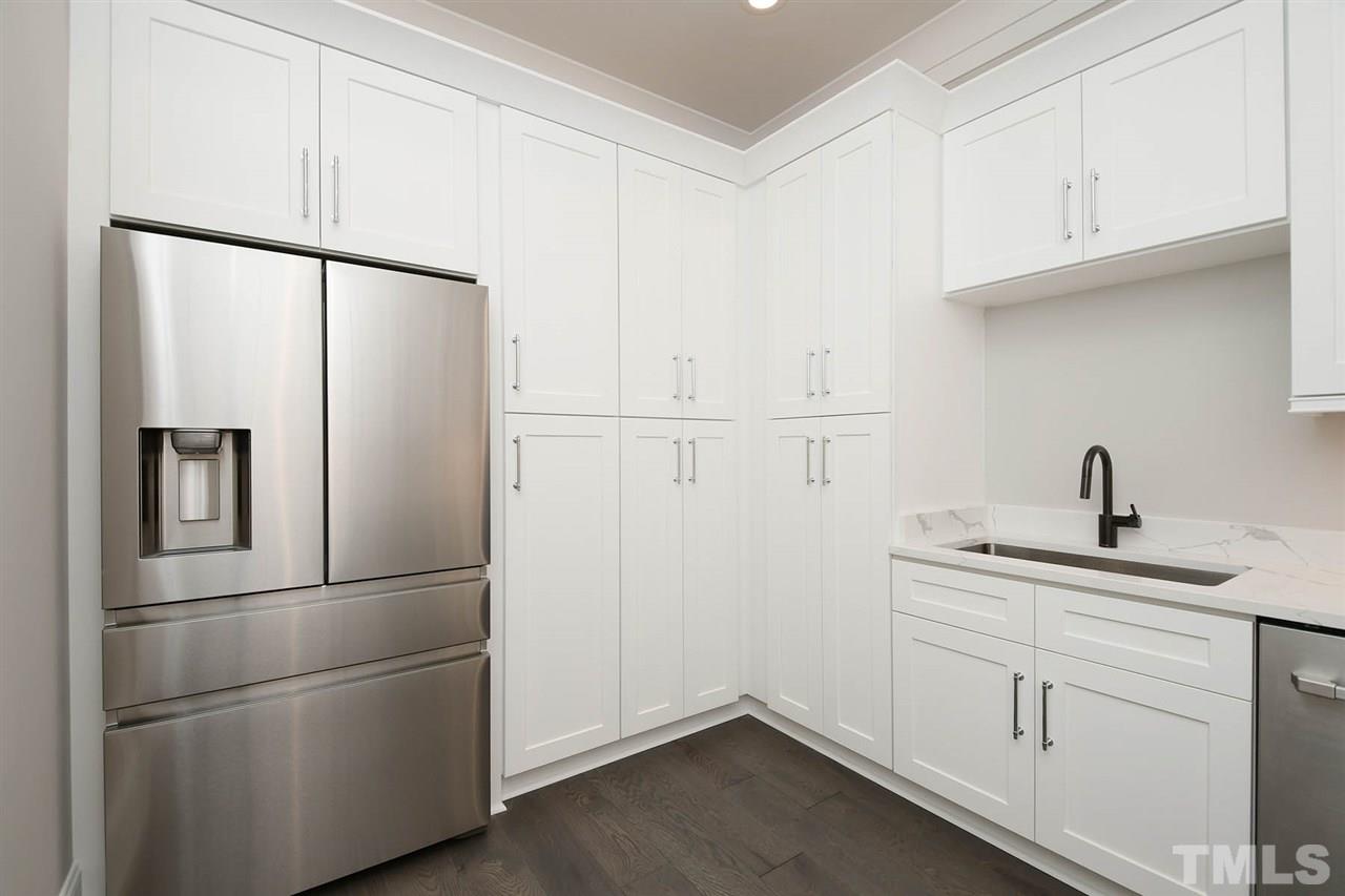1417 Sky Vista Way Raleigh, NC 27613 - Photo 16 of 26 a kitchen with cabinets and stainless steel appliances