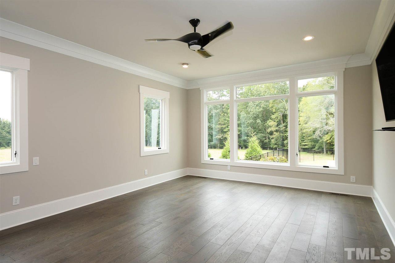 1417 Sky Vista Way Raleigh, NC 27613 - Photo 19 of 26 a view of empty room with wooden floor and fan