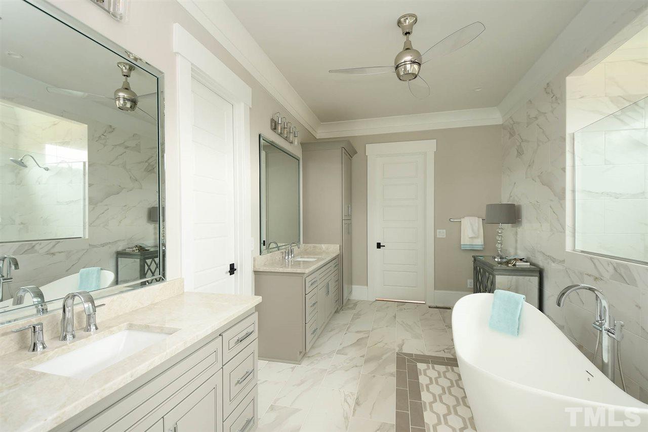 1417 Sky Vista Way Raleigh, NC 27613 - Photo 20 of 26 a spacious bathroom with a granite countertop sink a toilet a mirror and bathtub