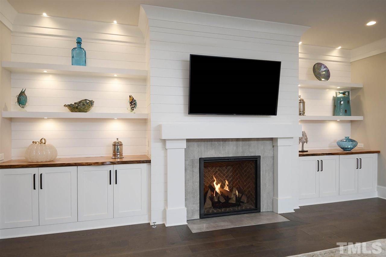 1417 Sky Vista Way Raleigh, NC 27613 - Photo 7 of 26 a living room with furniture a flat screen tv and a fireplace