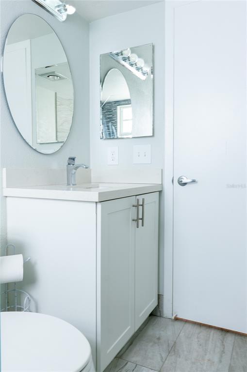 592 Fanshaw O, Unit 592 Boca Raton, FL 33434 - Photo 11 of 25 a bathroom with a toilet a sink and a mirror