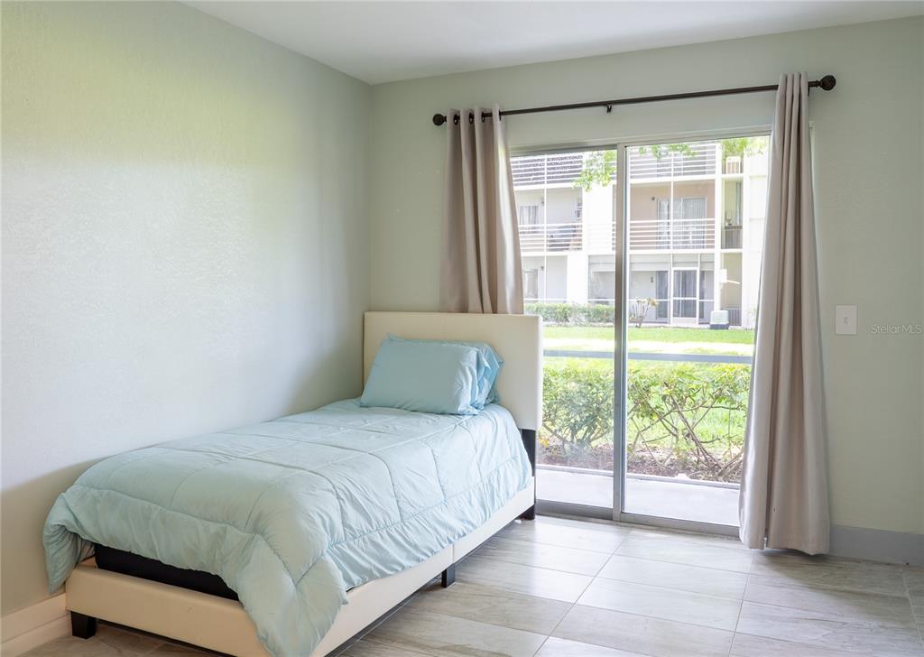 592 Fanshaw O, Unit 592 Boca Raton, FL 33434 - Photo 14 of 25 a bedroom with a bed and a window