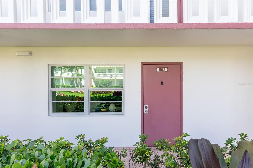 592 Fanshaw O, Unit 592 Boca Raton, FL 33434 - Photo 16 of 25 a front view of a house with a yard