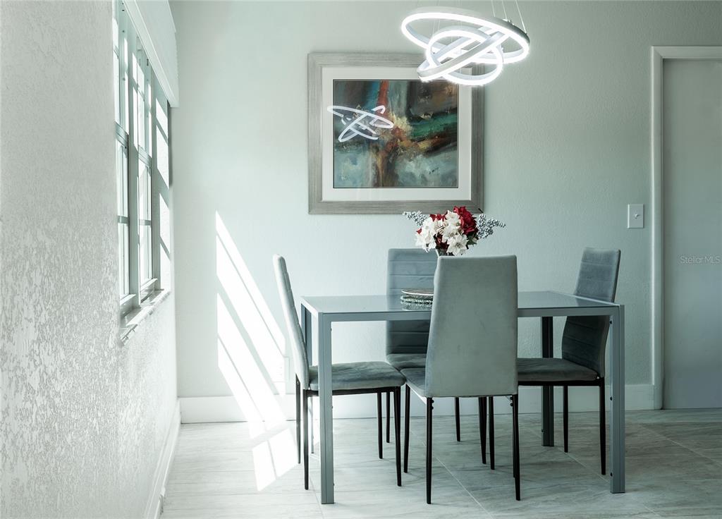 592 Fanshaw O, Unit 592 Boca Raton, FL 33434 - Photo 5 of 25 a dining room with furniture and window