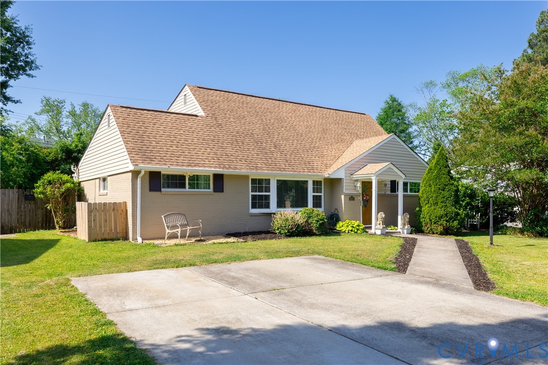 9217 Fisk Road Richmond, VA 23229 - Photo 3 of 39 a front view of a house with a yard and potted plants