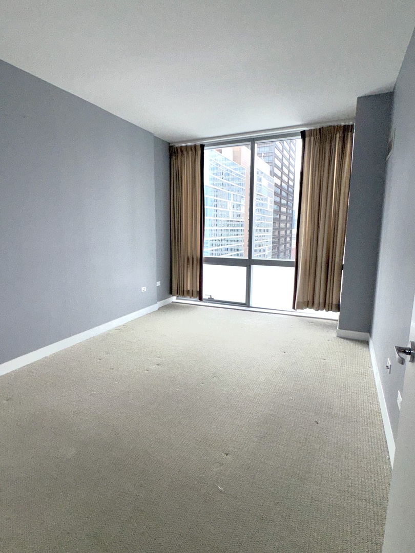 Undisclosed Address Chicago, IL 60601 - Photo 12 of 18 a view of an empty room with a window