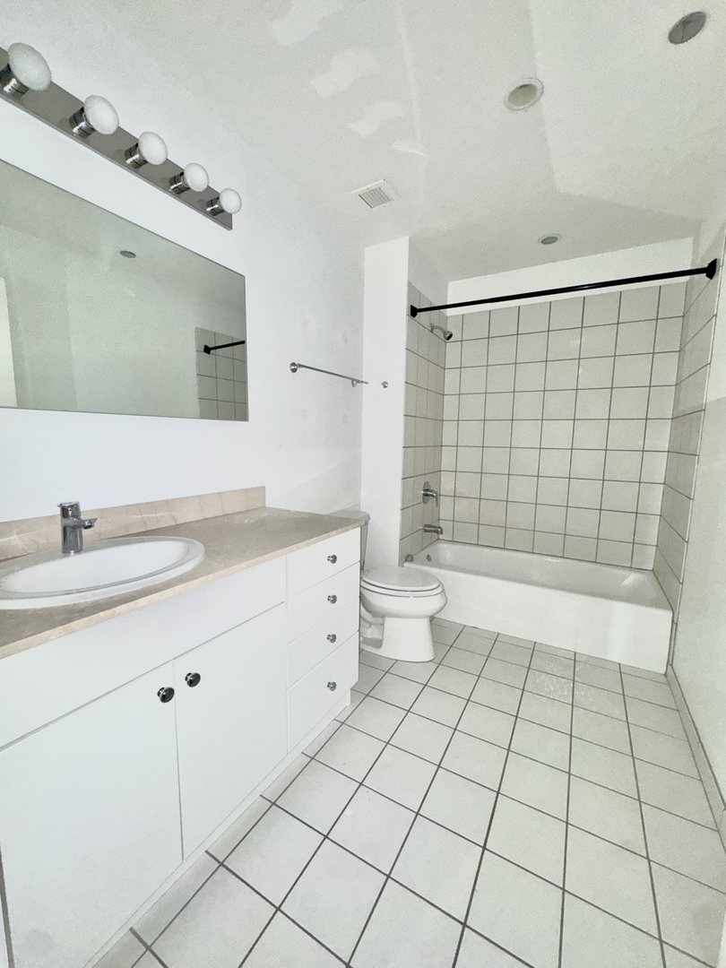 Undisclosed Address Chicago, IL 60601 - Photo 14 of 18 a bathroom with a sink a toilet and a mirror