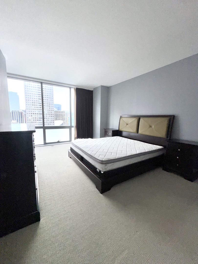 Undisclosed Address Chicago, IL 60601 - Photo 15 of 18 a bedroom with a bed and window