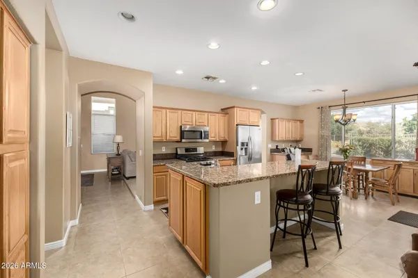 a kitchen with lots of counter top space and painting on the wall